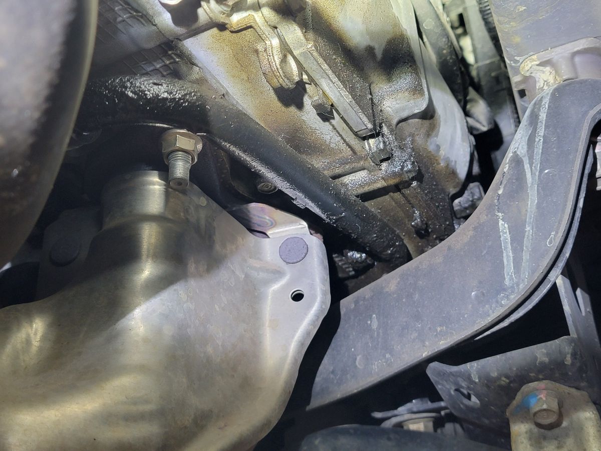 Oil residue on engine component showing the difference between a seep and a leak